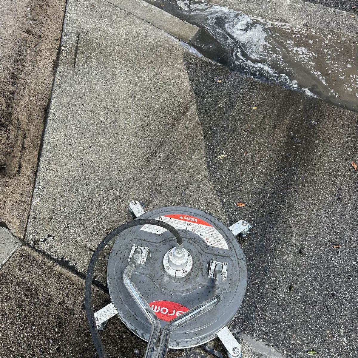 Freshly pressure washed concrete walkway showing a clean line