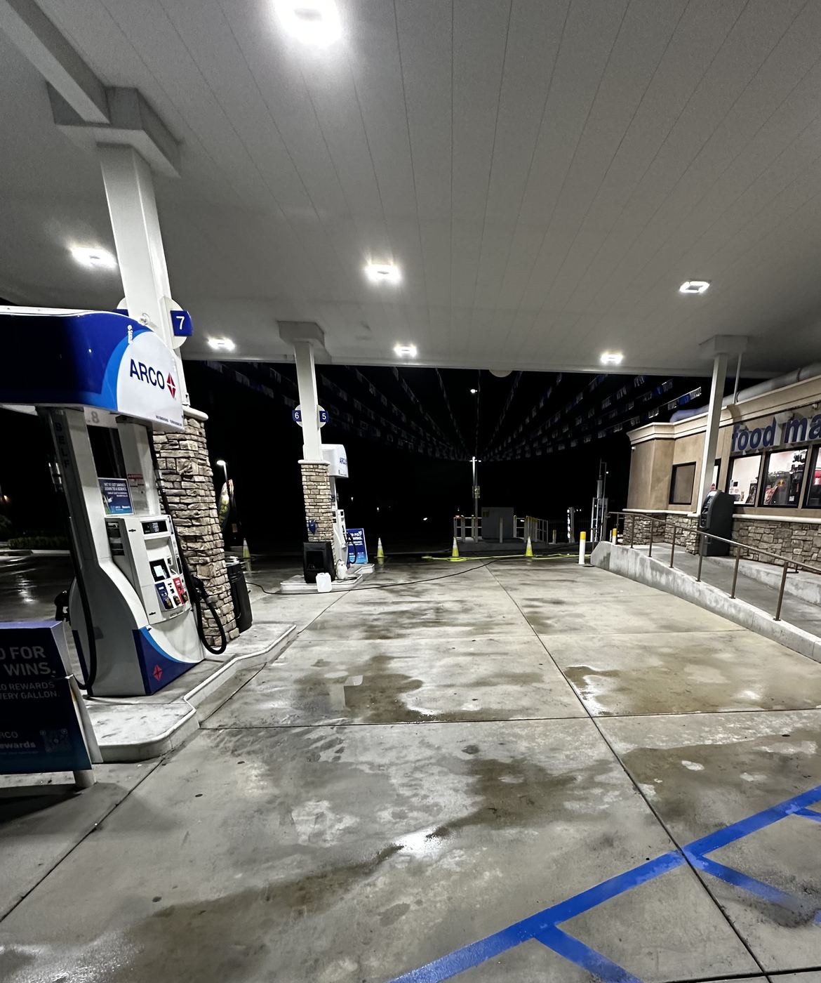 After: freshly cleaned gas station fuel island at night