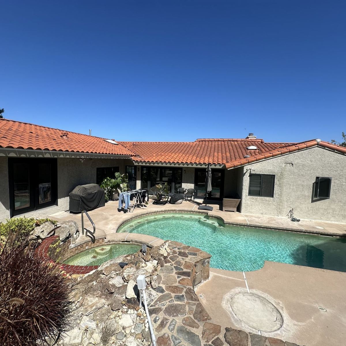 Clean tile roof over a South Bay hillside home with pool